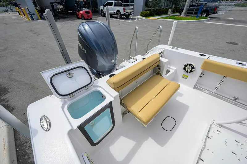 Slide: The Image of 2024 Sportsman Open 232 Center Console boat with Yamaha engine and tan seating. - 45