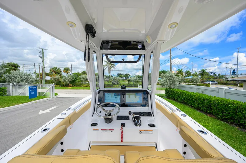Slide: The Image of 2024 Sportsman Open 232 Center Console boat interior with steering wheel and navigation display. - 28