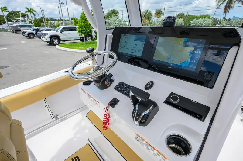 Slide: The Image of 2024 Sportsman Open 232 Center Console boat dashboard with navigation screens and controls. - 29