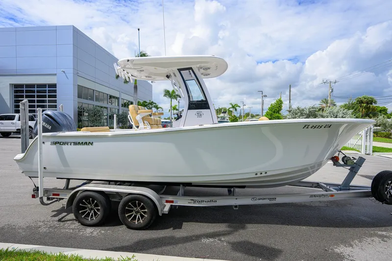 Slide: The Image of 2024 Sportsman Open 232 Center Console boat on trailer, parked outdoors. - 7