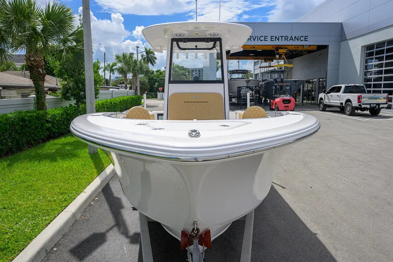 Slide: The Image of 2024 Sportsman Open 232 Center Console boat at service entrance, sunny day. - 16