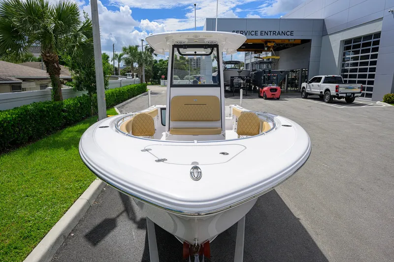 Slide: The Image of 2024 Sportsman Open 232 Center Console boat at service entrance, sunny day. - 17