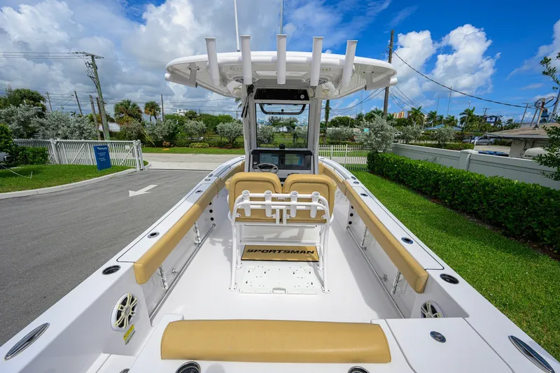 Slide: The Image of 2024 Sportsman Open 232 Center Console boat with tan seating and rod holders. - 3