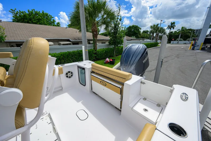 Slide: The Image of 2024 Sportsman Open 232 Center Console boat interior with tan seating and Yamaha engine. - 39