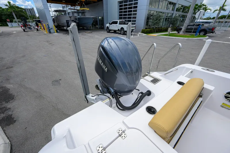 Slide: The Image of 2024 Sportsman Open 232 Center Console boat with Yamaha engine at a marina. - 14