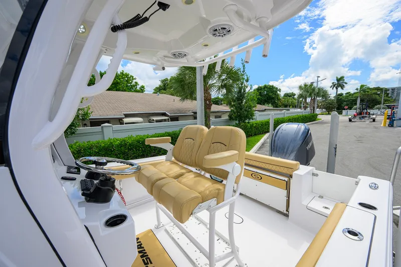 Slide: The Image of 2024 Sportsman Open 232 Center Console boat interior with helm and seating. - 33