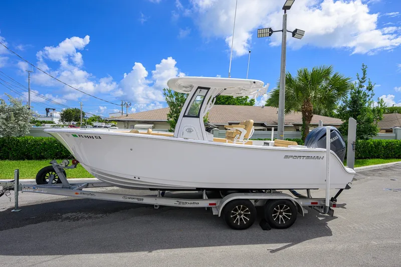 Slide: The Image of 2024 Sportsman Open 232 Center Console boat on trailer, sunny day background. - 6