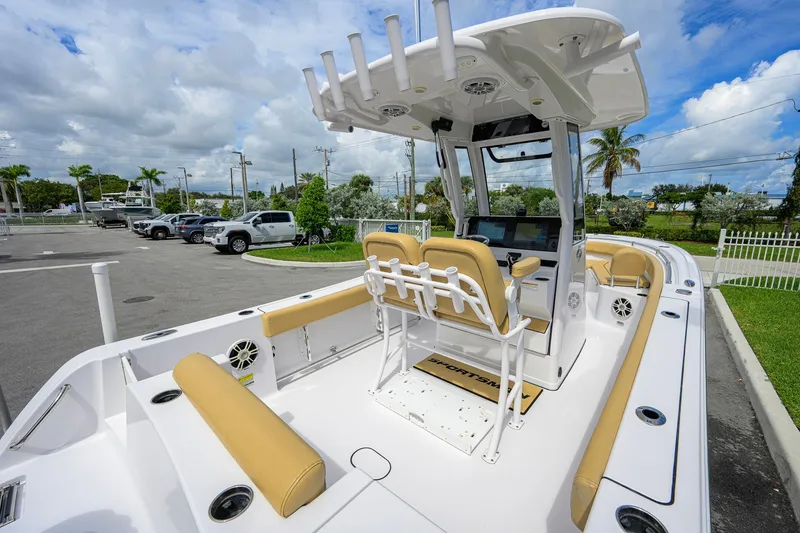 Slide: The Image of 2024 Sportsman Open 232 Center Console boat with tan seating and modern helm. - 37