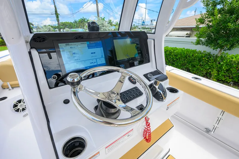 Slide: The Image of 2024 Sportsman Open 232 Center Console dashboard with steering wheel and navigation screens. - 30