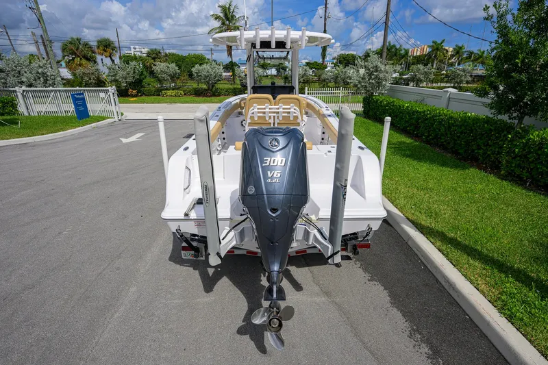 Slide: The Image of 2024 Sportsman Open 232 Center Console boat with Yamaha 300 V6 engine, parked outdoors. - 12