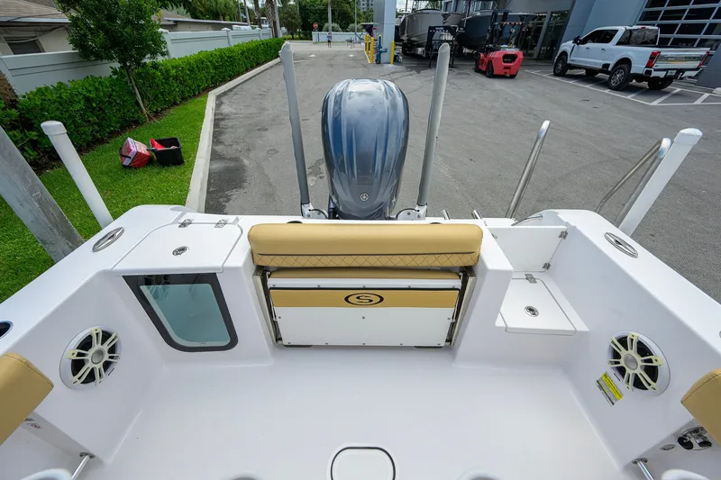 Slide: The Image of 2024 Sportsman Open 232 Center Console boat interior with seating and motor view. - 41