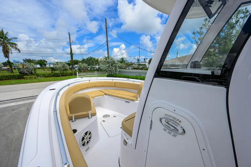 Slide: The Image of 2024 Sportsman Open 232 Center Console boat with tan seating and sleek design. - 25
