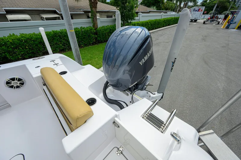 Slide: The Image of 2024 Sportsman Open 232 Center Console with Yamaha outboard engine, docked outdoors. - 15