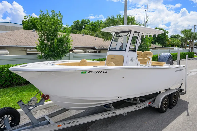 Slide: The Image of 2024 Sportsman Open 232 Center Console boat on trailer, parked outdoors. - 5