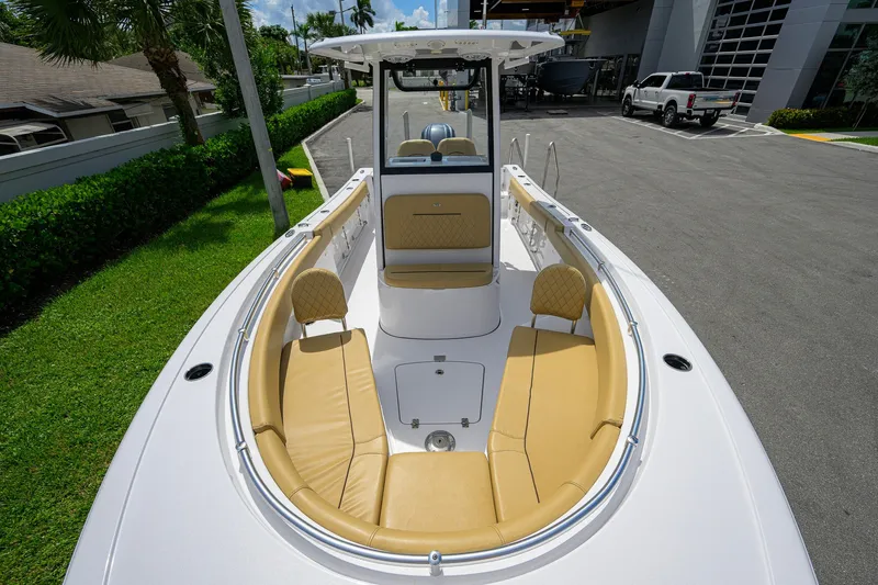 Slide: The Image of 2024 Sportsman Open 232 Center Console boat with tan seating and sleek design. - 4