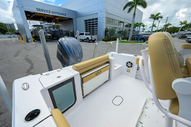 Slide: The Image of 2024 Sportsman Open 232 Center Console at service entrance, showcasing seating and engine. - 40