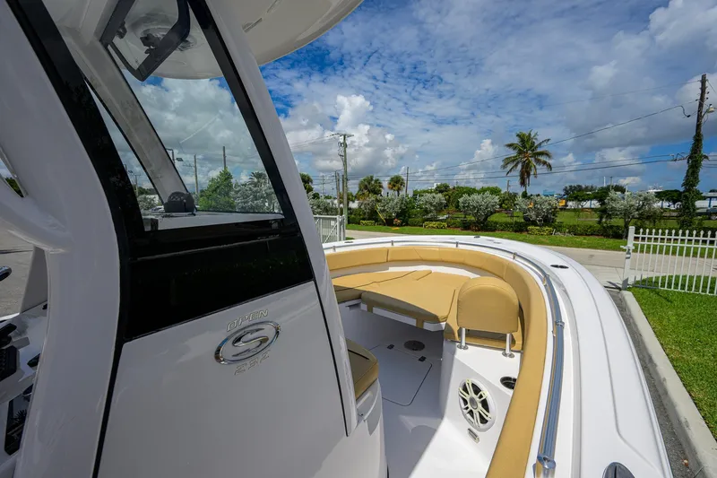 Slide: The Image of 2024 Sportsman Open 232 Center Console boat with tan seating, under a blue sky. - 26