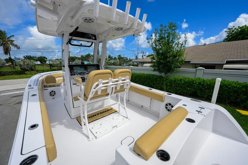 Slide: The Image of 2024 Sportsman Open 232 Center Console boat with tan seating and modern design. - 36