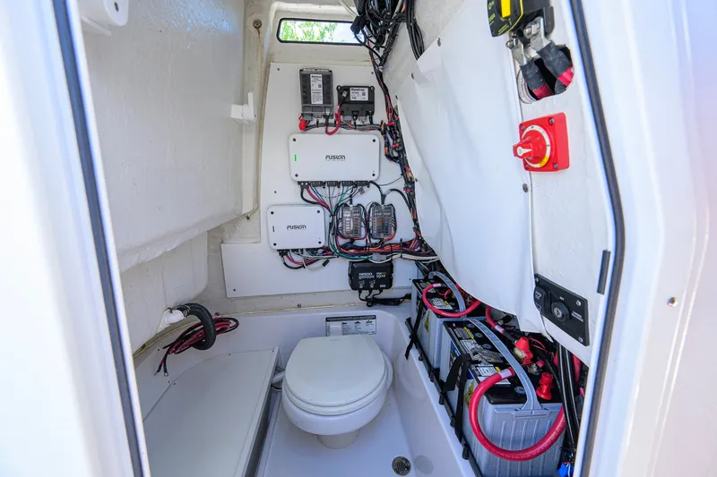 Slide: The Image of 2024 Sportsman Open 232 Center Console interior with wiring and marine toilet. - 51