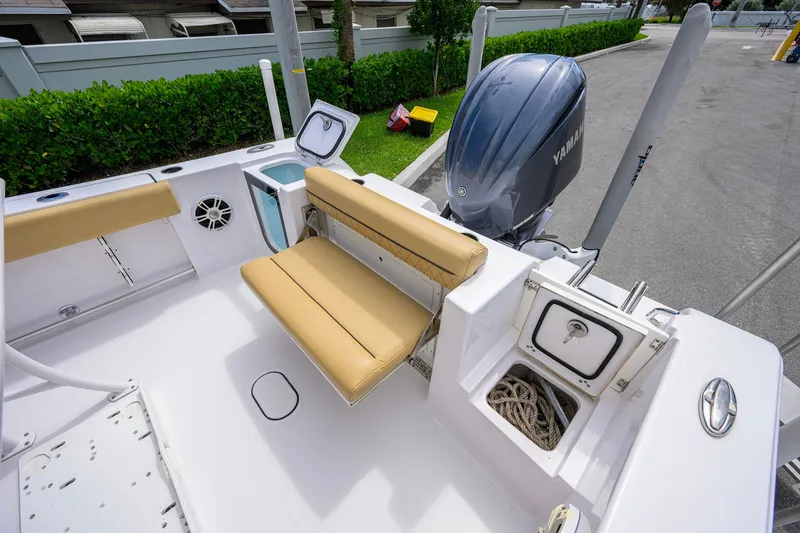 Slide: The Image of 2024 Sportsman Open 232 Center Console boat interior with seating and storage compartments. - 44