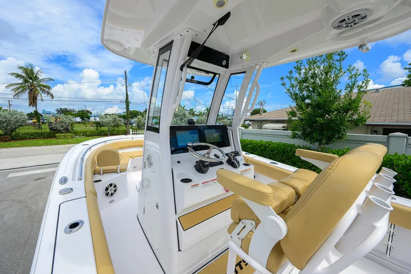 Slide: The Image of 2024 Sportsman Open 232 Center Console boat interior with helm and seating. - 27