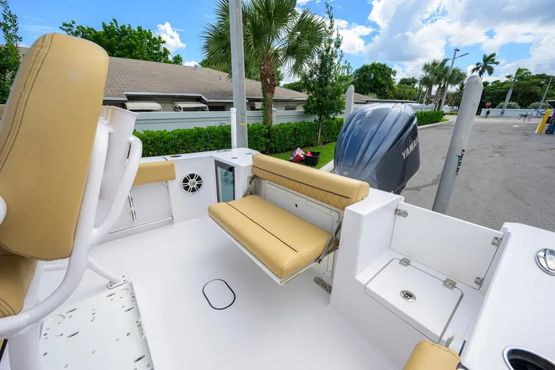 Slide: The Image of 2024 Sportsman Open 232 Center Console boat with tan seating and Yamaha engine. - 42