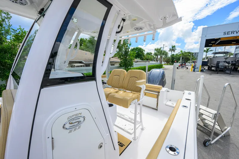 Slide: The Image of 2024 Sportsman Open 232 Center Console boat with tan seating and modern design. - 32