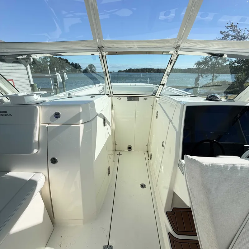 Slide: The Image of Cobia 330 Dual Console 2023 with spacious cockpit and panoramic water view. - 9