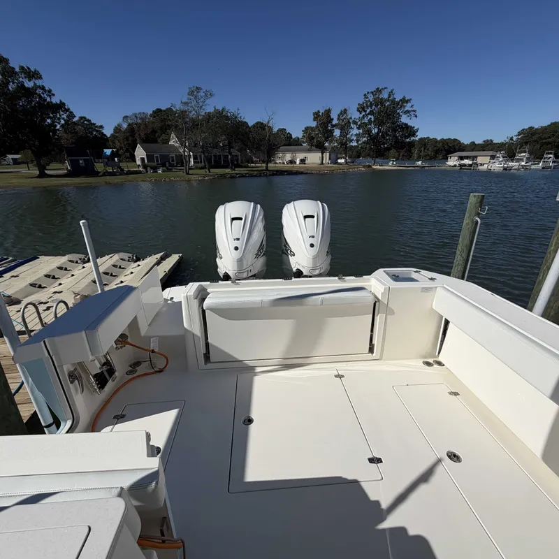 Slide: The Image of The image shows the stern of a Cobia 330 Dual Console boat with two outboard engines. - 6