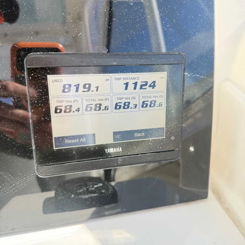 Slide: The Image of Yamaha screen displaying engine hours and total distance, with a reflective background. - 14