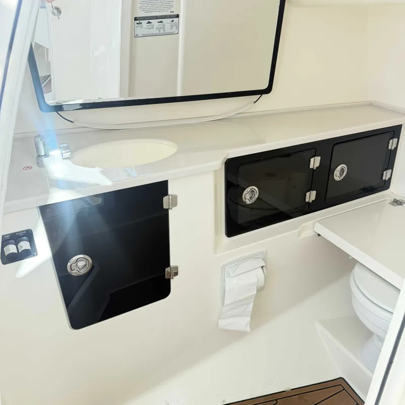 Slide: The Image of Interior of a modern boat cabin with a sink, mirror, and storage compartments. - 13