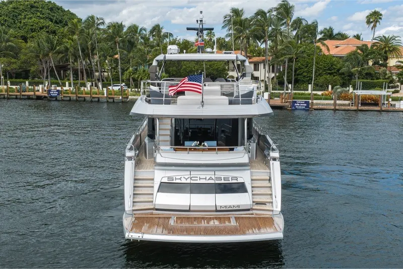 Slide: The Image of 2018 Sunseeker 86 Yacht "Skychaser" docked in a scenic waterfront location. - 6