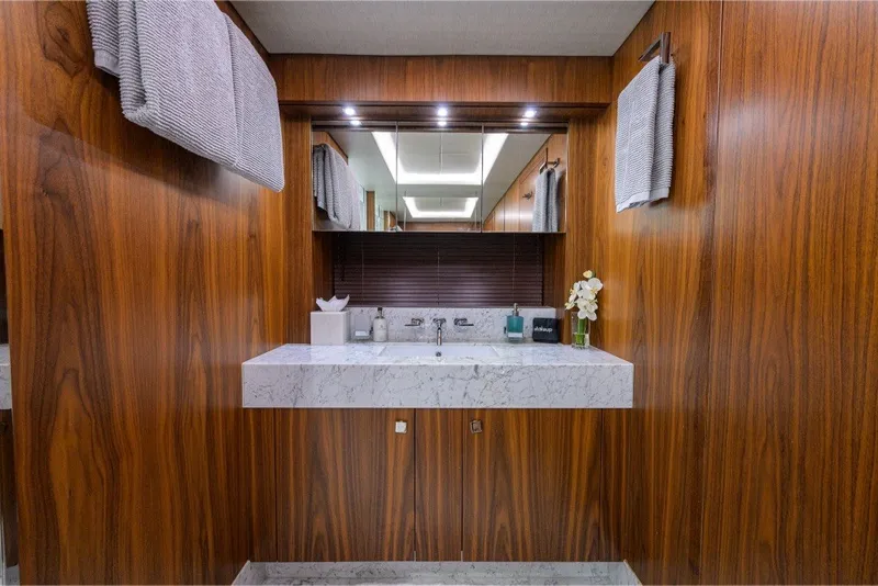 Slide: The Image of Luxurious bathroom with marble sink and wooden paneling on a 2018 Sunseeker 86 Yacht. - 42