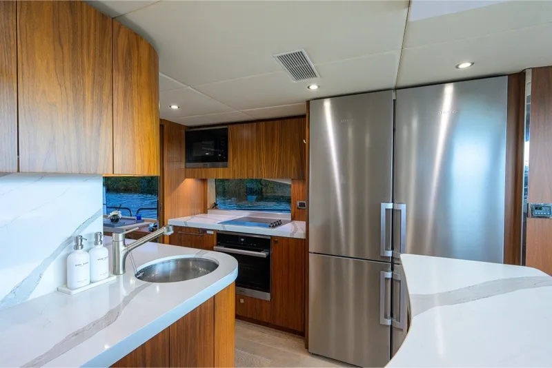 Slide: The Image of Luxurious kitchen interior of 2018 Sunseeker 86 Yacht with modern appliances and wood finish. - 26