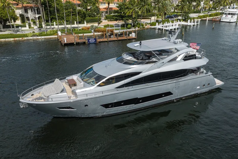 Slide: The Image of Luxurious 2018 Sunseeker 86 Yacht cruising on a scenic waterfront. - 3