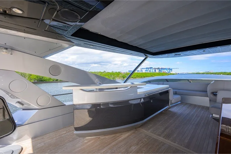 Slide: The Image of Luxurious 2018 Sunseeker 86 Yacht interior with sleek bar and scenic water view. - 64