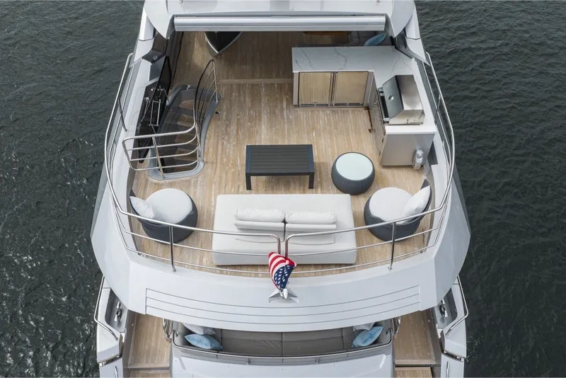 Slide: The Image of Luxurious 2018 Sunseeker 86 Yacht deck with seating, table, and kitchenette. - 56