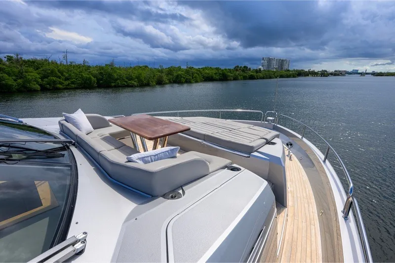 Slide: The Image of Luxurious 2018 Sunseeker 86 Yacht with elegant deck seating and scenic water view. - 70