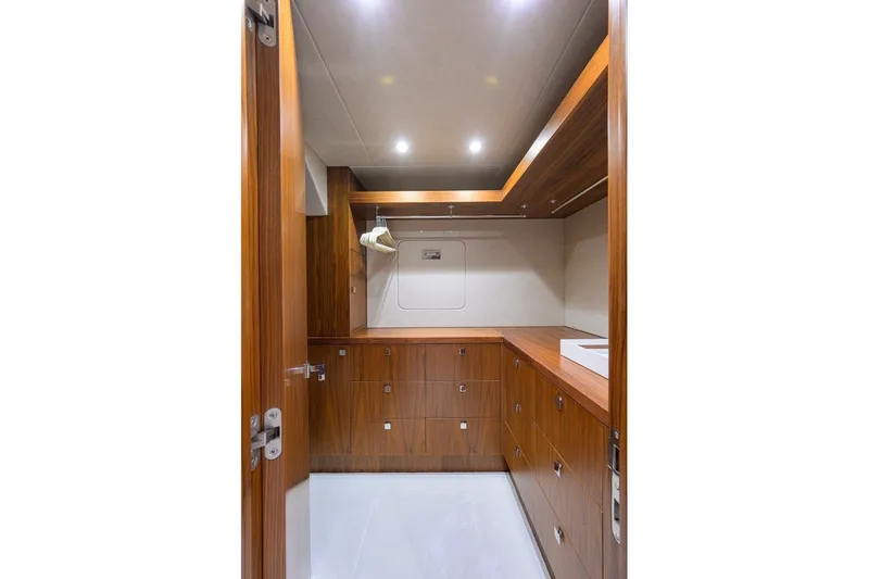 Slide: The Image of Luxurious wooden interior of 2018 Sunseeker 86 Yacht, featuring ample storage and modern design. - 34