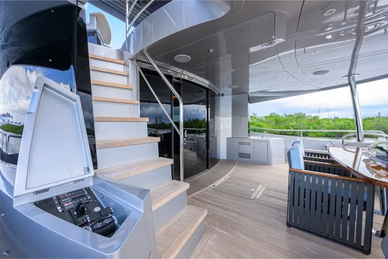Slide: The Image of Luxurious 2018 Sunseeker 86 Yacht deck with modern seating and elegant staircase. - 13