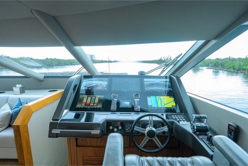 Slide: The Image of Luxurious 2018 Sunseeker 86 Yacht helm with advanced navigation systems and panoramic views. - 27