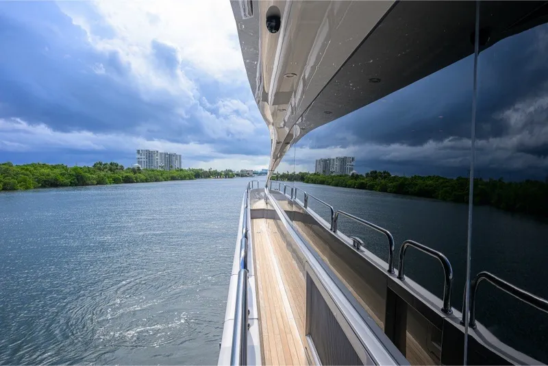 Slide: The Image of Side view of a 2018 Sunseeker 86 Yacht cruising on a scenic waterway. - 55