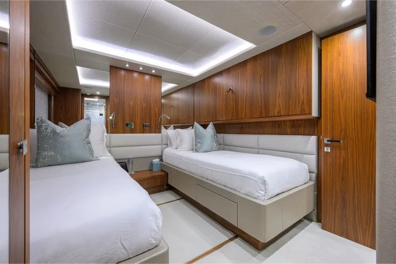 Slide: The Image of Luxurious twin bedroom on 2018 Sunseeker 86 Yacht with elegant wood paneling. - 51