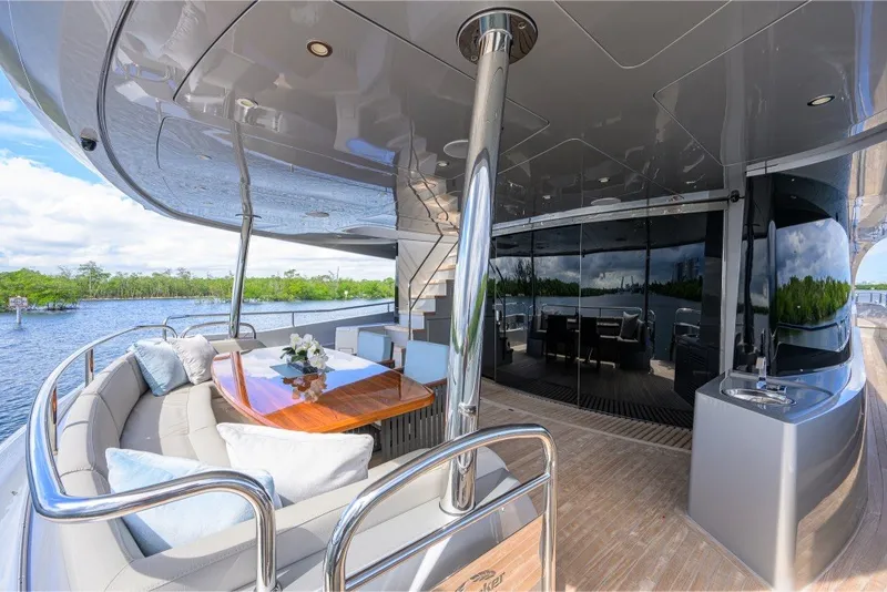 Slide: The Image of Luxurious 2018 Sunseeker 86 Yacht deck with elegant seating and dining area. - 10