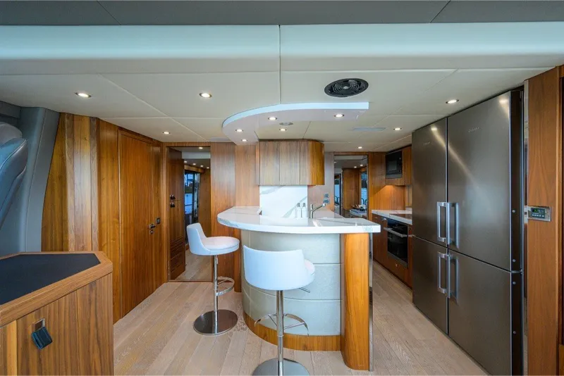 Slide: The Image of Luxurious interior of 2018 Sunseeker 86 Yacht with modern kitchen and bar seating. - 25