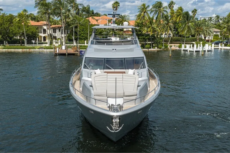 Slide: The Image of 2018 Sunseeker 86 Yacht on water, surrounded by palm trees and luxury homes. - 5