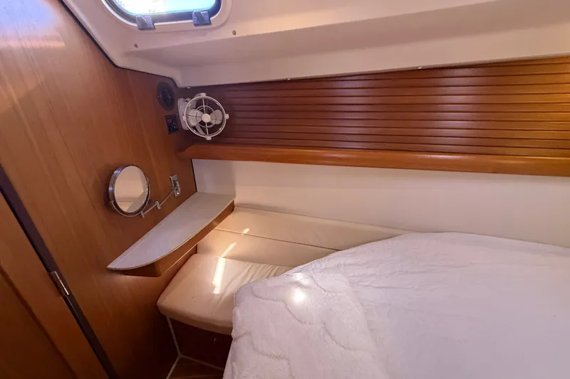 Slide: The Image of Cozy cabin interior of 2014 Catalina 445 sailboat with wooden accents and bedding. - 56