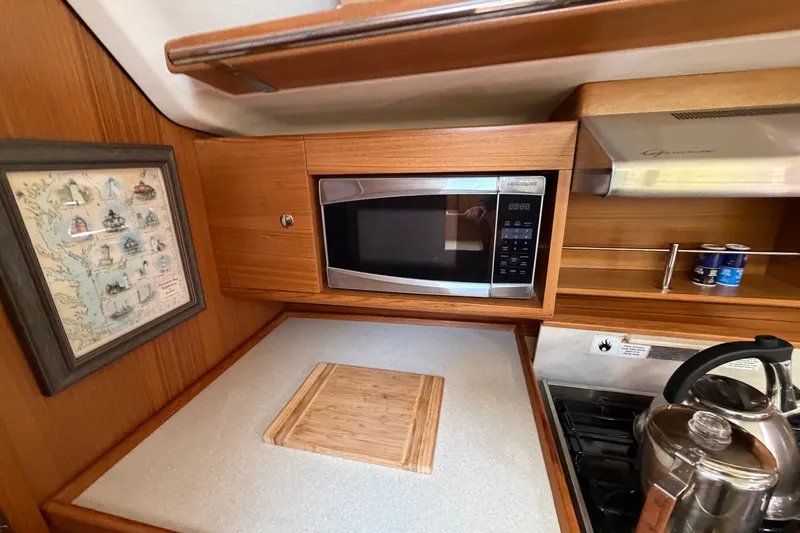Slide: The Image of Galley kitchen in 2014 Catalina 445 yacht with microwave, stove, and kettle. - 33