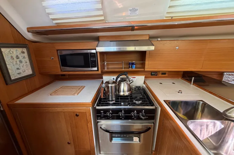 Slide: The Image of Catalina 445 yacht kitchen interior with stove, microwave, and sink, 2014 model. - 34