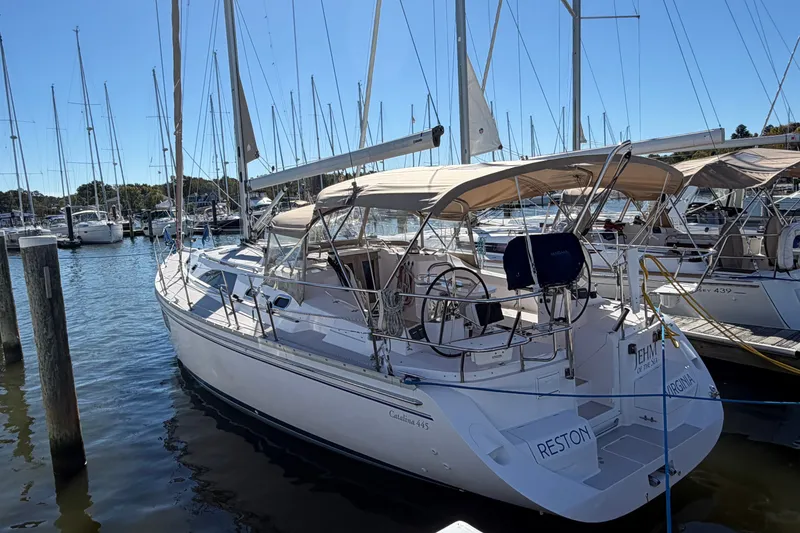 The Image of 2014 Catalina 445 sailboat docked at marina, featuring spacious deck and dual steering wheels. - 0